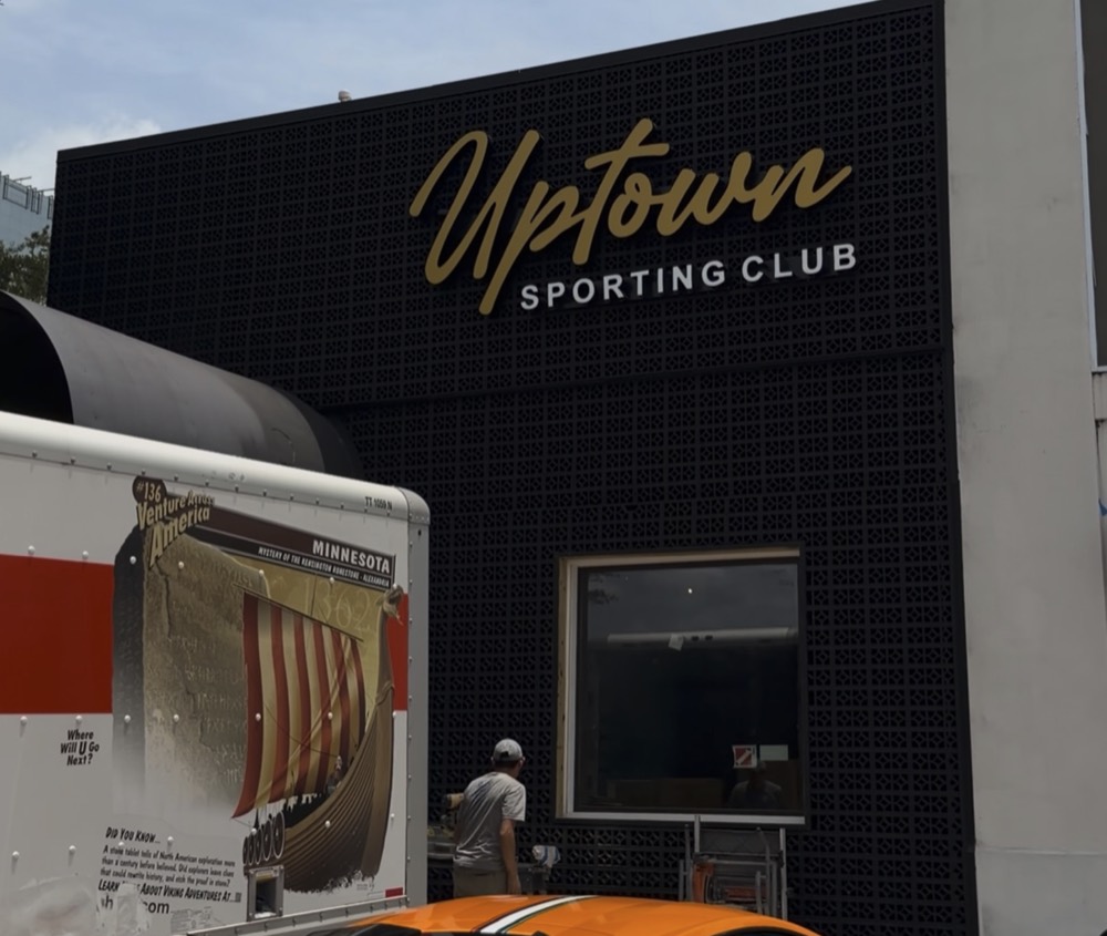 Uptown Sporting Club dimensional letters on black facade